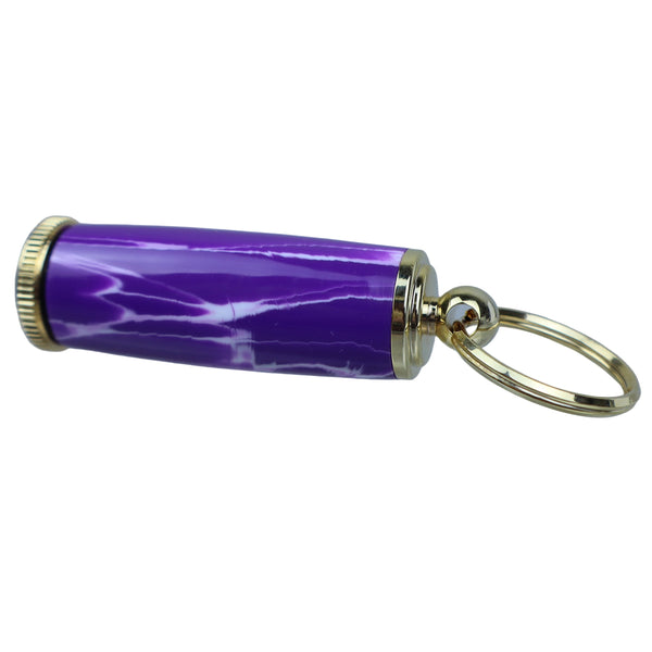 Purple cylindrical keychain with gold accents on a clear stand against a gray background