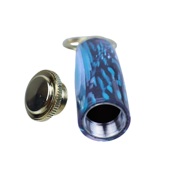 Two bottle caps, one gold and one with a blue and black pattern, on a clear background.
