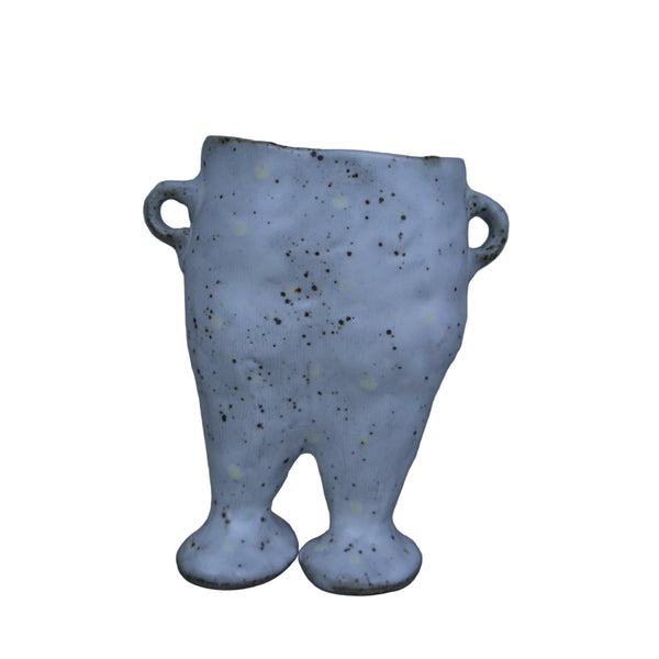 Speckled ceramic vase on a gray background