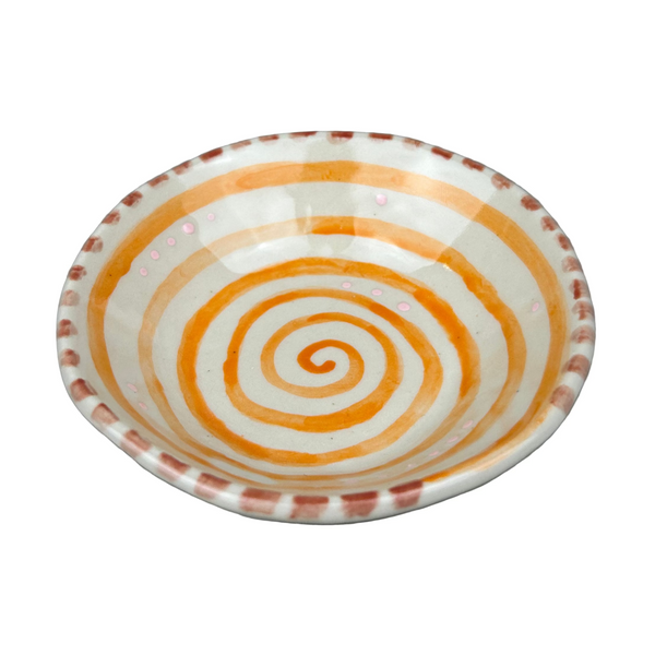 Small ceramic dish with spiral pattern on a gray background