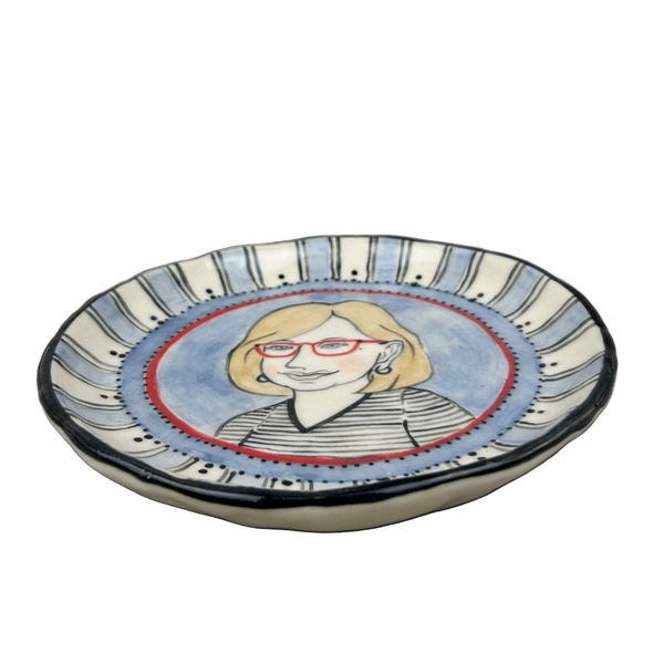 Ceramic plate with a portrait of a person on a gray background