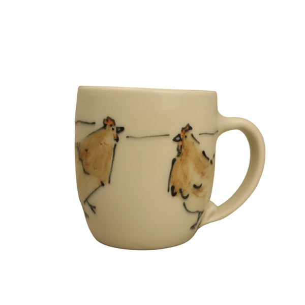 White mug with chicken illustrations on a beige background