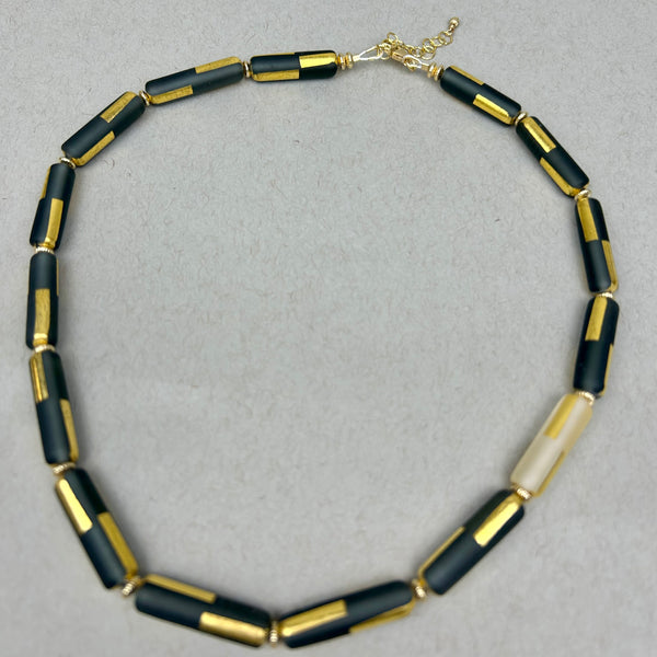 Black sandblasted glass necklace by Minori Takagi with 24K gold leaf detail and 14K gold filled chain, 18 inches long.