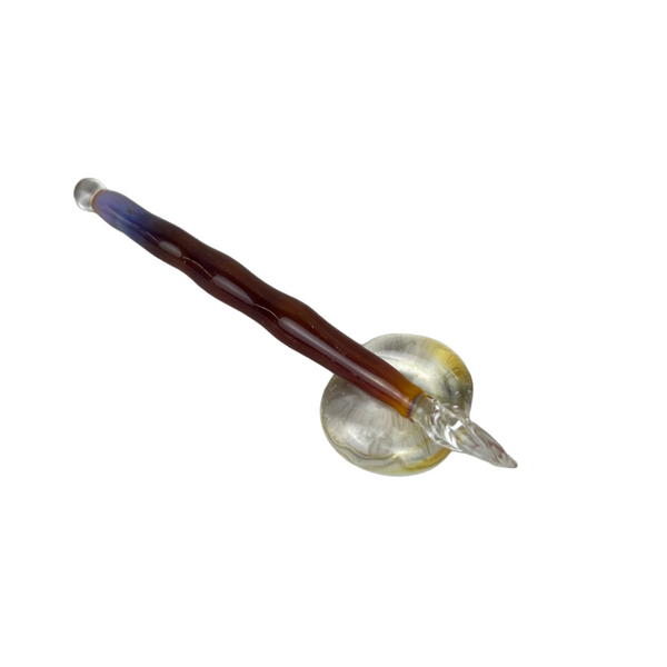Handcrafted glass dip pen and tester pen set in swirling purple and gold tones, displayed together on a neutral background