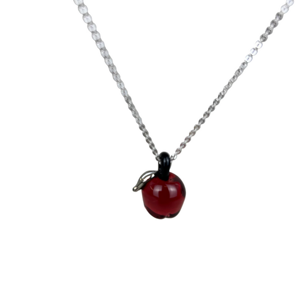 Necklace with a red apple pendant on a light gray background