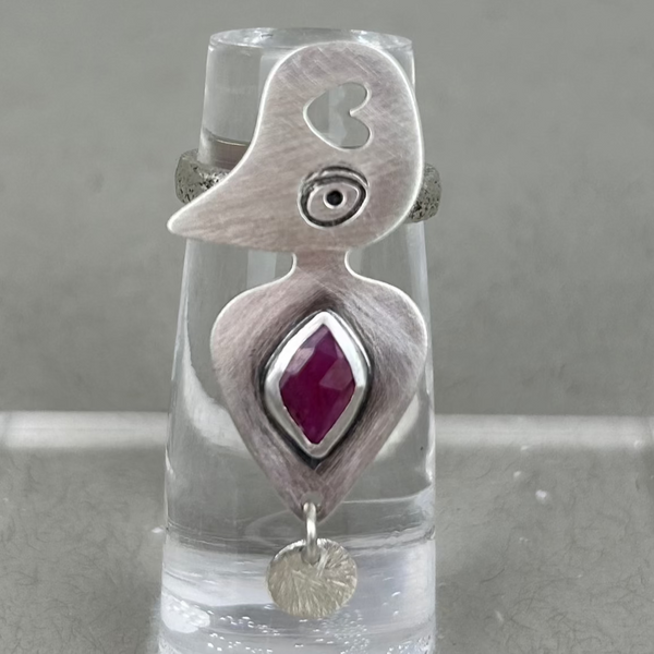 Sterling silver ring with organic hive-like design, featuring a natural ruby at the center.