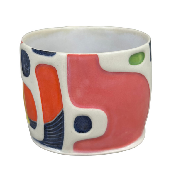 Ceramic cup with colorful abstract design on a gray background