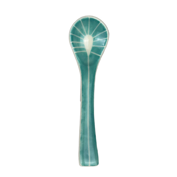 Teal ceramic spoon on a gray background