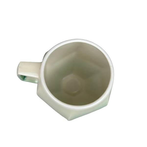 White ceramic mug on a gray background