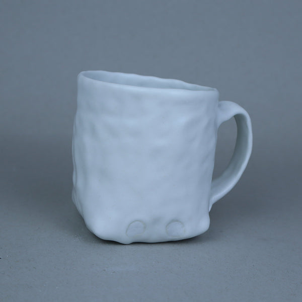 White textured mug on a black background