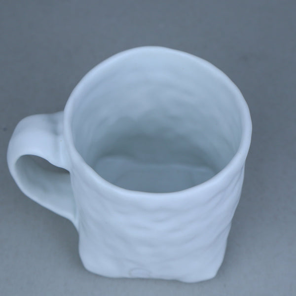 Hand built porcelain cup with folded base