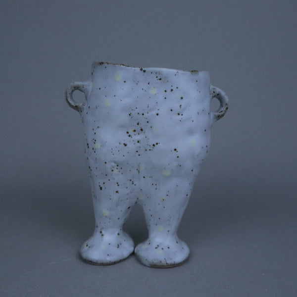 Speckled ceramic vase on a gray background