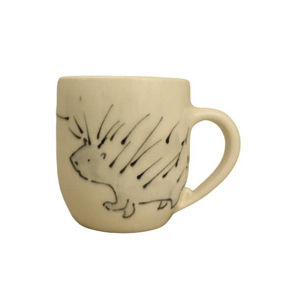White mug with black hedgehog design on a beige background
