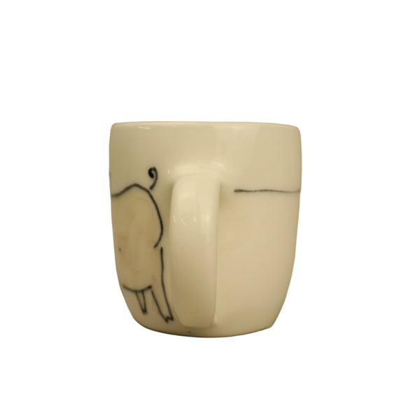 White ceramic mug with black handle and minimalistic design on a beige background