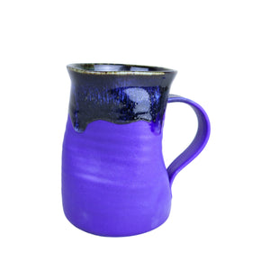 Purple ceramic mug with black interior on a white background