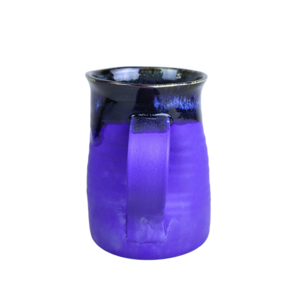 Purple glass vase with black rim on a white background