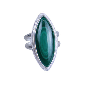 Silver ring with a green gemstone on a light gray background
