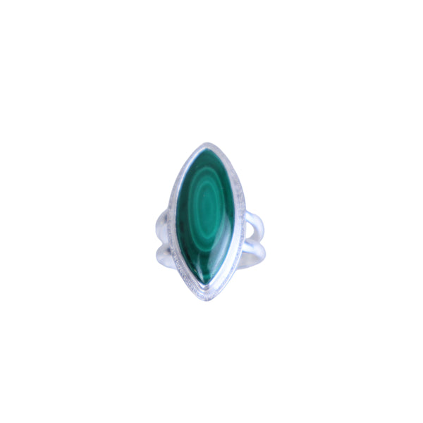 Silver ring with a green gemstone on a light gray background