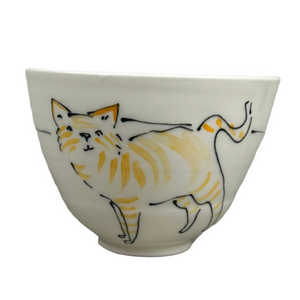 Small white bowl with a cat illustration on a gray background