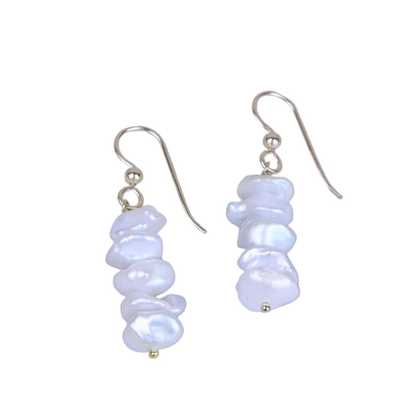 Pair of pearl earrings on a light gray background
