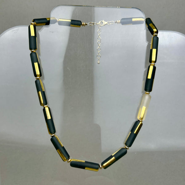Black sandblasted glass necklace by Minori Takagi with 24K gold leaf detail and 14K gold filled chain, 18 inches long.