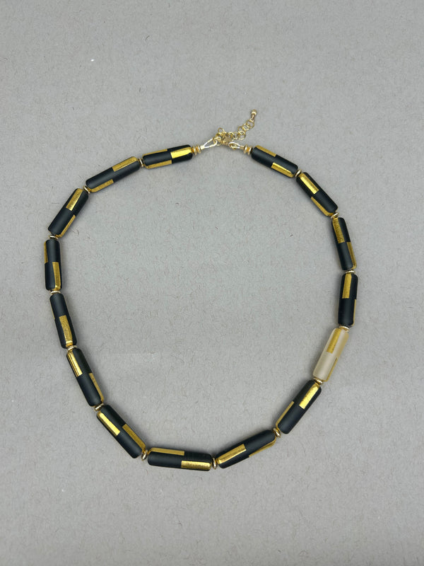 Black sandblasted glass necklace by Minori Takagi with 24K gold leaf detail and 14K gold filled chain, 18 inches long.