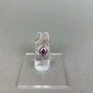Sterling silver ring with organic hive-like design, featuring a natural ruby at the center.