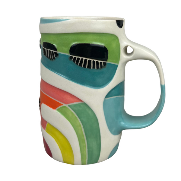 Colorful ceramic mug with abstract design on a gray background