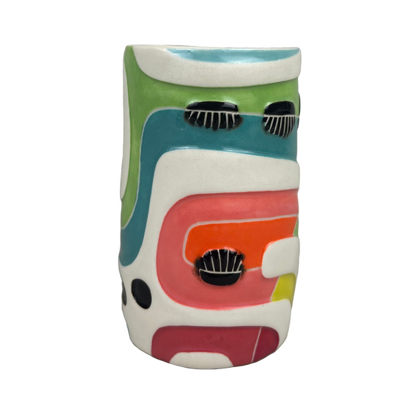 Colorful ceramic mug with abstract design on a gray background