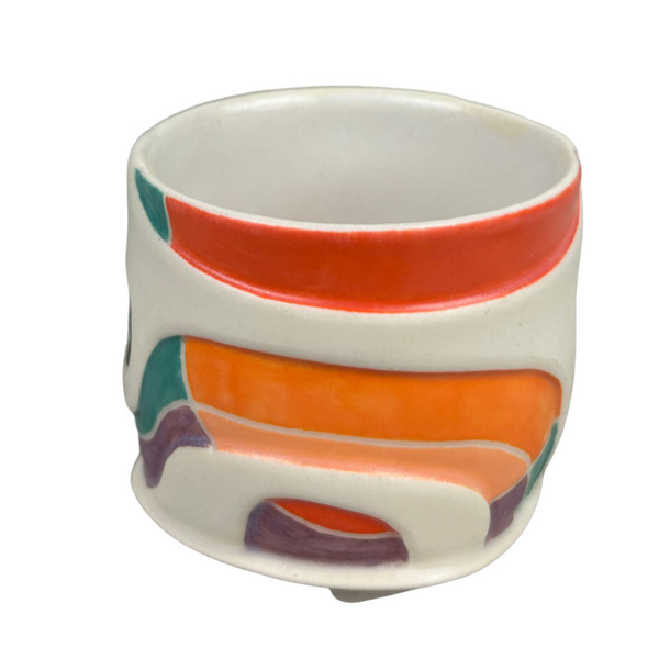 Ceramic cup with colorful abstract design on a gray background