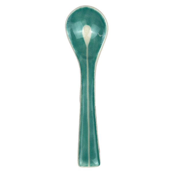 Teal ceramic spoon on a gray background