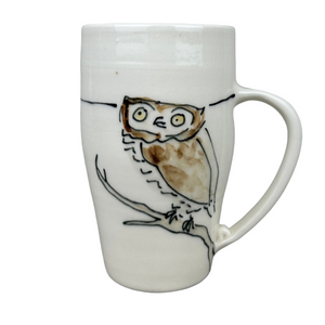 White mug with an owl design on a gray background