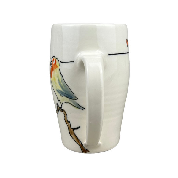 White mug with a bird design on a gray background