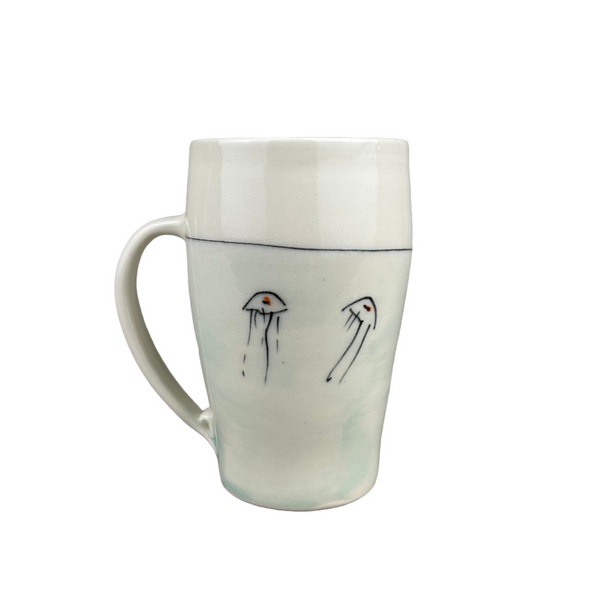 White ceramic mug with small black drawings on a gray background