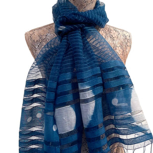 Blue patterned scarf on a mannequin against a white background