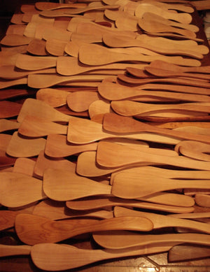 Collection of wooden spoons on a dark surface