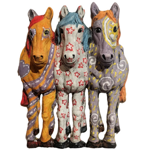 Three colorful horse figurines with decorative patterns on a white background