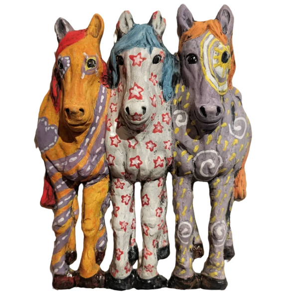 Three colorful horse figurines with decorative patterns on a white background
