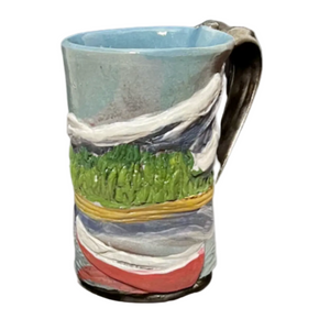 Ceramic mug with landscape design on a white background