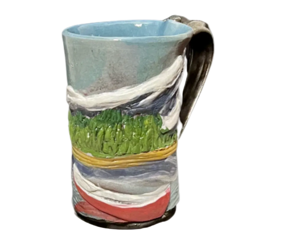 Ceramic mug with landscape design on a white background