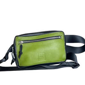 A green and black leather crossbody bag with a front zippered pocket and a black strap, shown on a neutral gray background.