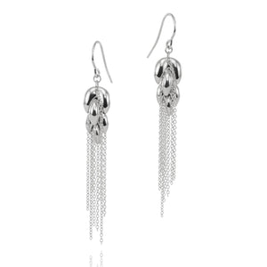 A pair of silver dangle earrings with textured bead-like tops and long chain fringe, shown on a clean white background with a faint reflection below.